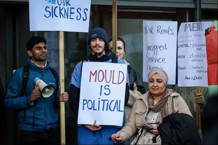 Protesters outside the Affordable Housing Awards in Manchester holding placards reading ‘Mould is Political’ and ‘Unfair rents’